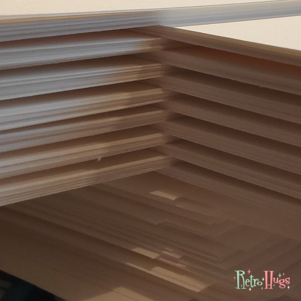 Planner inserts 2023; 14 stacks of 10 sheets of 160 grams creamy white paper, waiting to be printed.